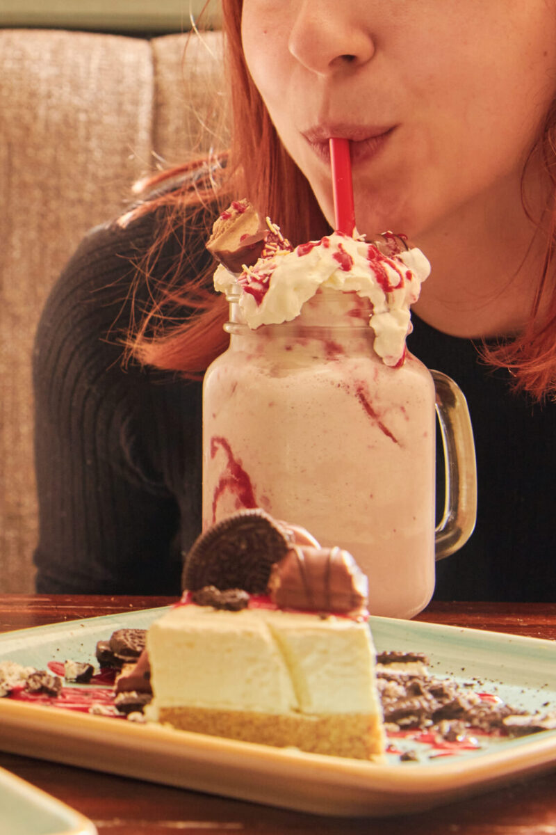 A girl drinking a milkshake.