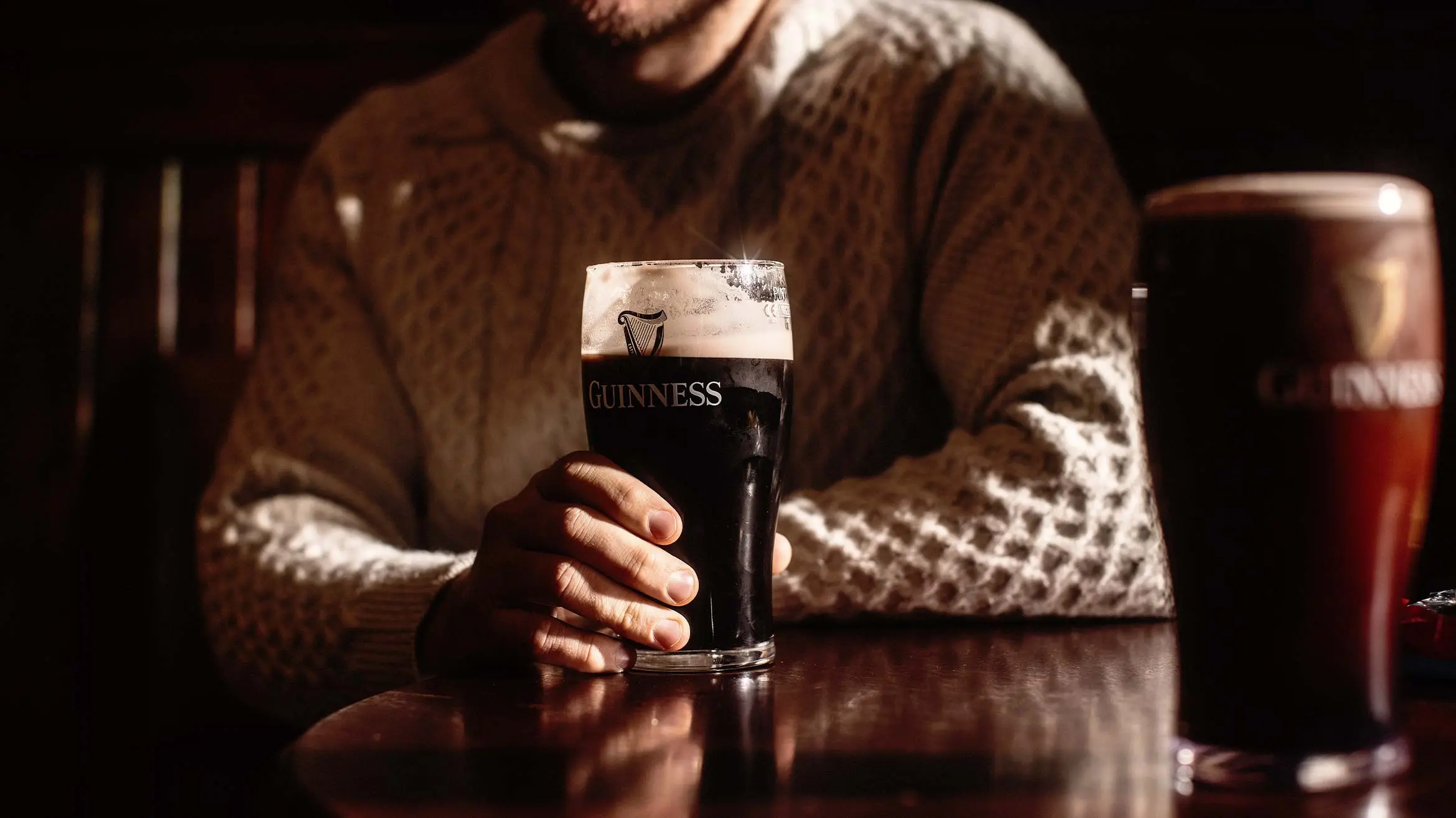 A man holding a pint.