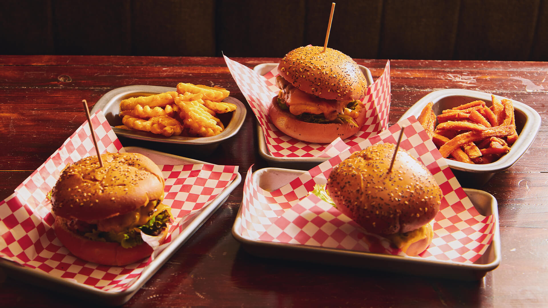 Hamburgers and fries on a table.