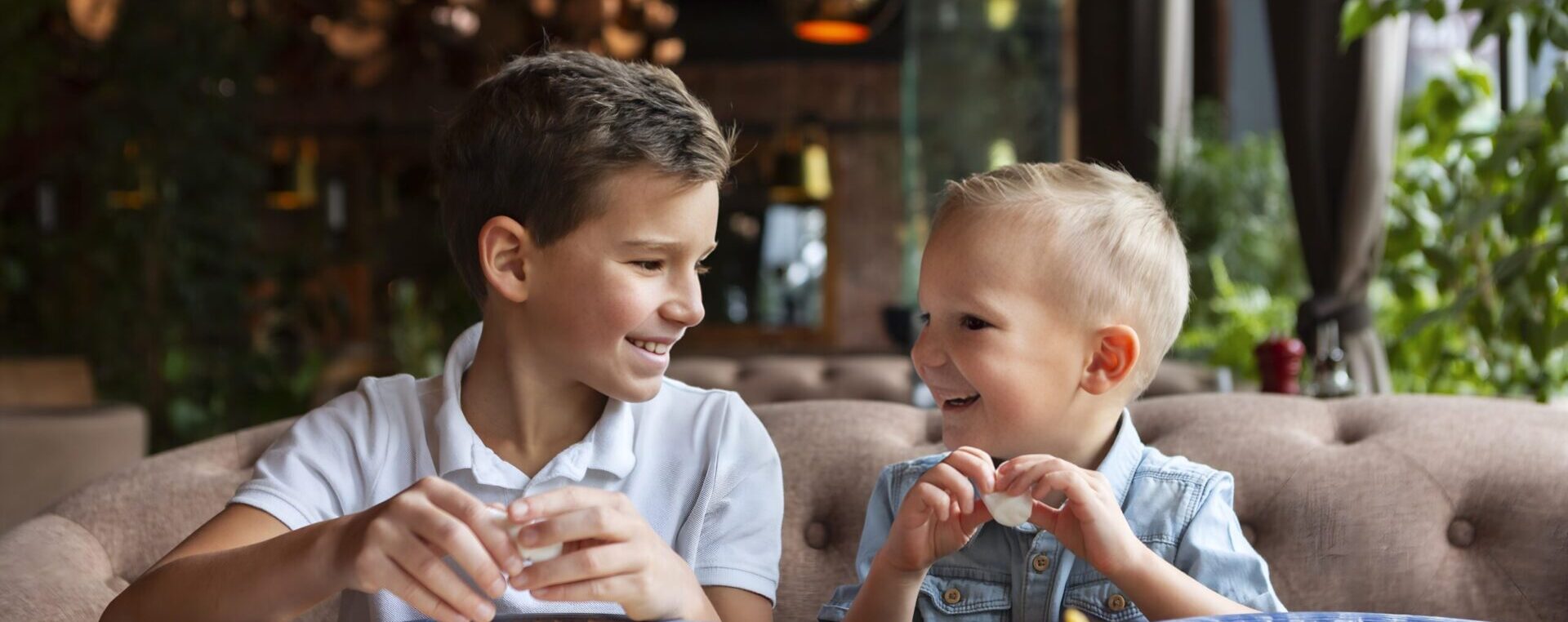 Two kids eating and smiling.