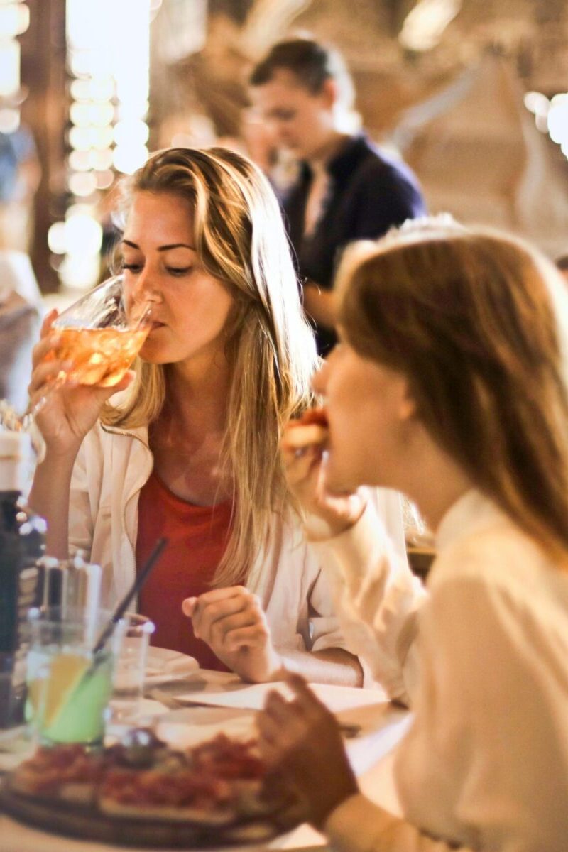 a woman drinking from a wineglass.
