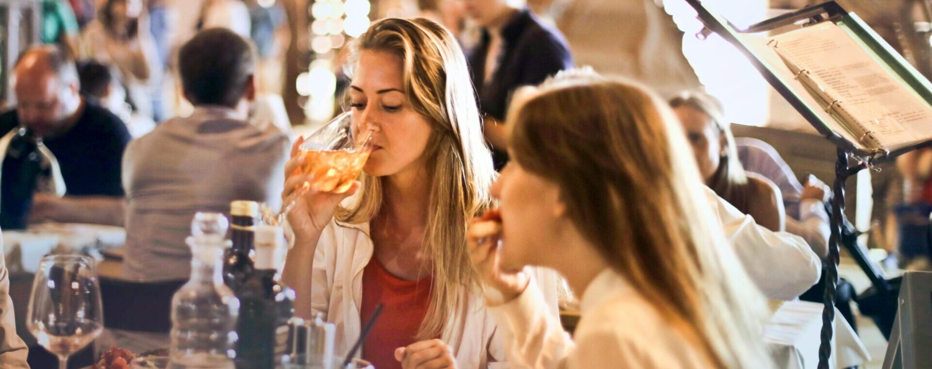 a woman drinking from a wineglass.