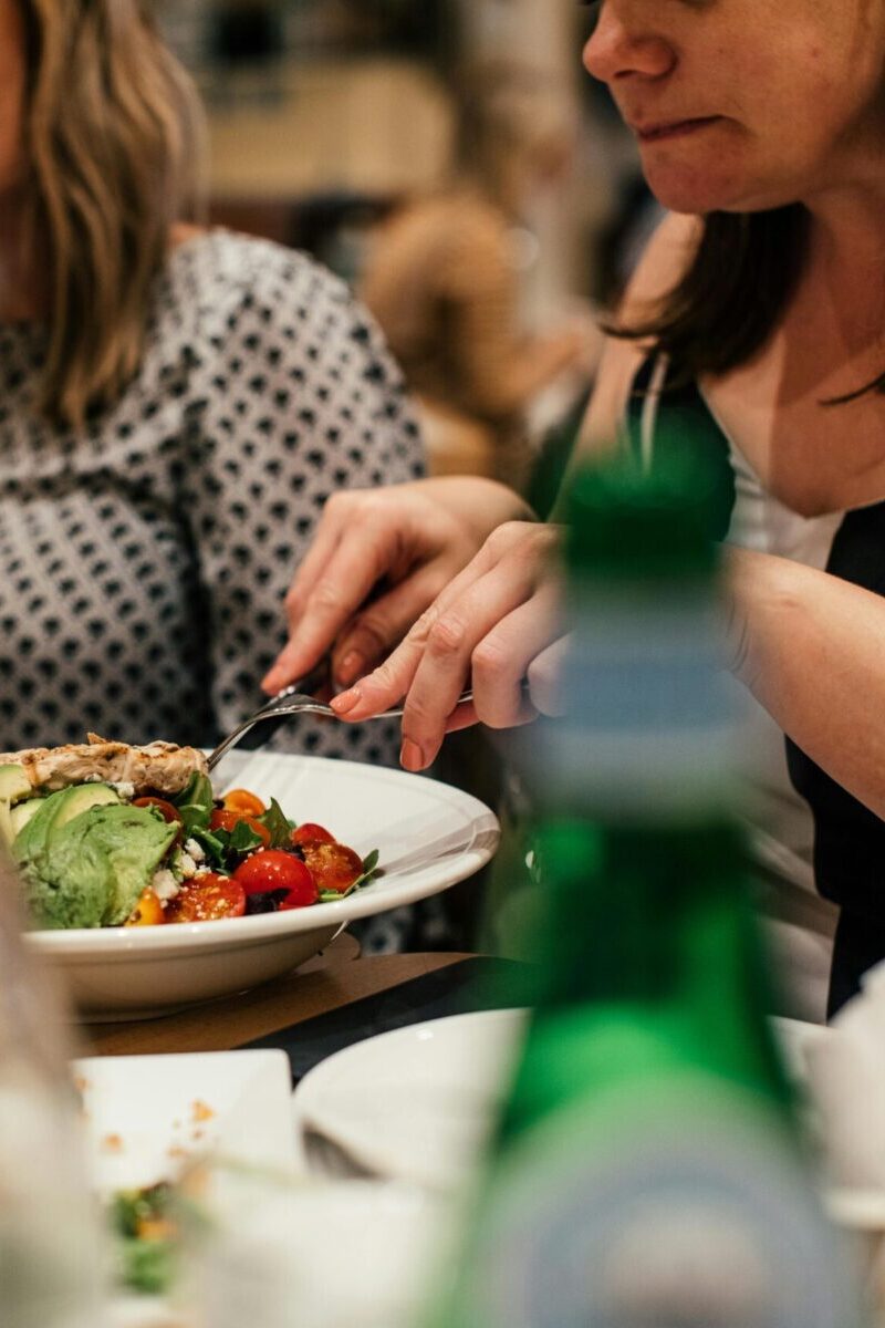 a woman cutting her food.